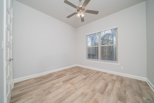 unfurnished room featuring a ceiling fan, baseboards, and light wood finished floors