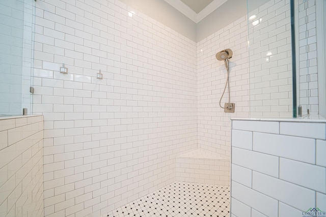 full bathroom with crown molding and tiled shower