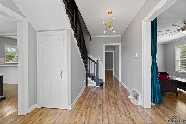 513 E Young, Longview, TX 75602 - foyer featuring stairway, wood finished floors, plenty of natural light, and crown molding