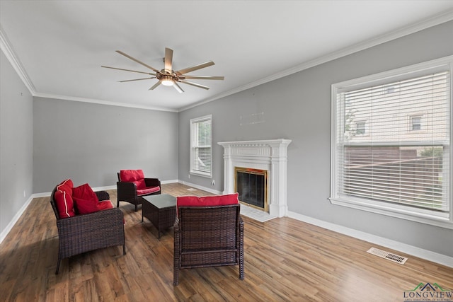513 E Young, Longview, TX 75602 - living room featuring wood finished floors, ceiling fan, ornamental molding, baseboards, and a fireplace with flush hearth