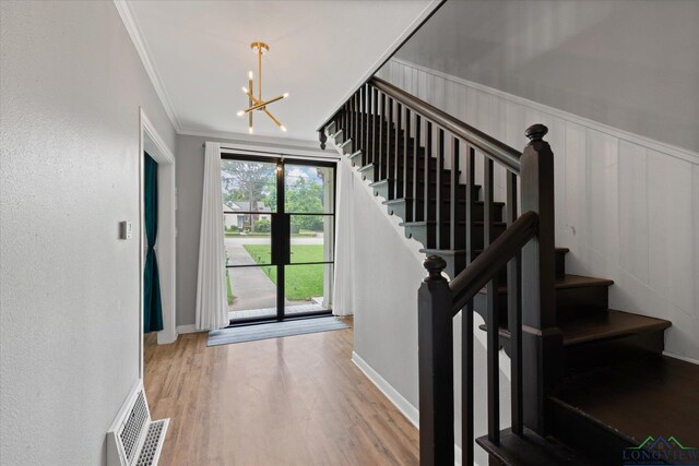 513 E Young, Longview, TX 75602 - stairway featuring a chandelier, wood finished floors, crown molding, and baseboards