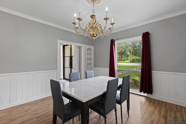 513 E Young, Longview, TX 75602 - dining space featuring a chandelier, wainscoting, crown molding, and wood finished floors
