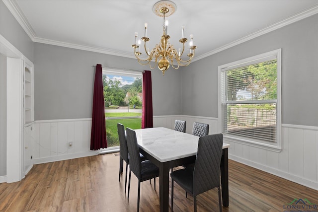 513 E Young, Longview, TX 75602 - dining space featuring a chandelier, wainscoting, wood finished floors, and ornamental molding