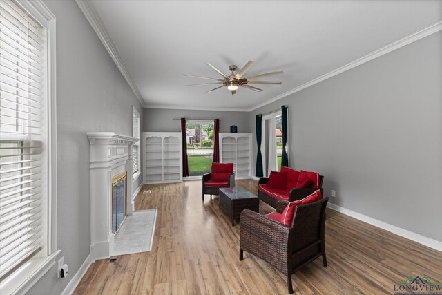 513 E Young, Longview, TX 75602 - sitting room with ceiling fan, wood finished floors, crown molding, and a glass covered fireplace