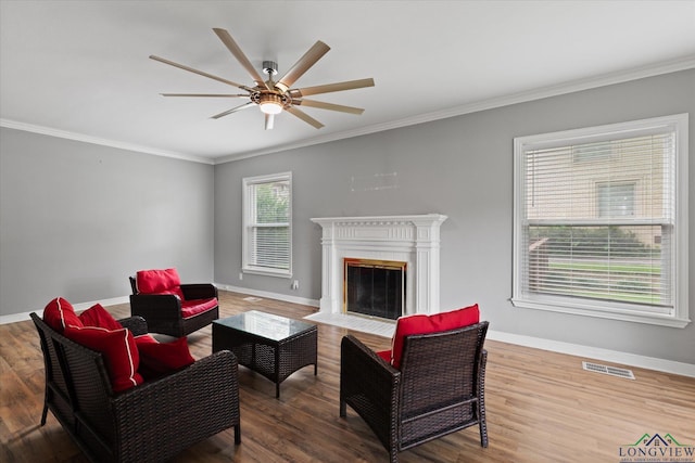 513 E Young, Longview, TX 75602 - living area with ceiling fan, crown molding, baseboards, wood finished floors, and a fireplace with flush hearth
