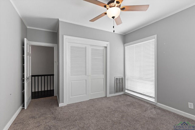 513 E Young, Longview, TX 75602 - unfurnished bedroom featuring carpet flooring, ornamental molding, a closet, and baseboards