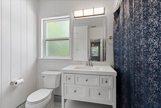 513 E Young, Longview, TX 75602 - bathroom featuring toilet, vanity, plenty of natural light, and a shower with shower curtain