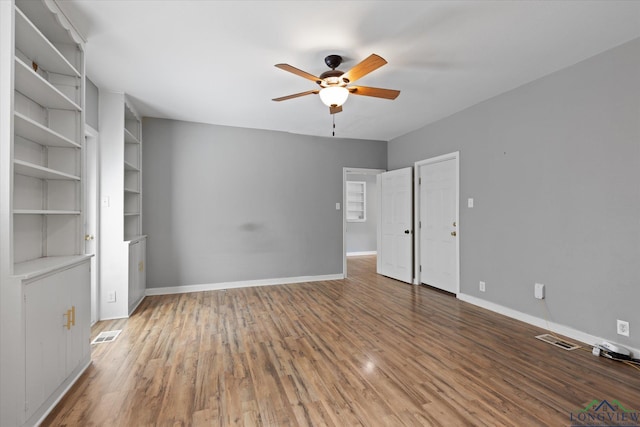 513 E Young, Longview, TX 75602 - unfurnished bedroom featuring light wood finished floors, baseboards, and a ceiling fan