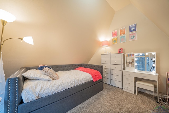 carpeted bedroom with vaulted ceiling