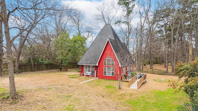 view of outbuilding featuring fence