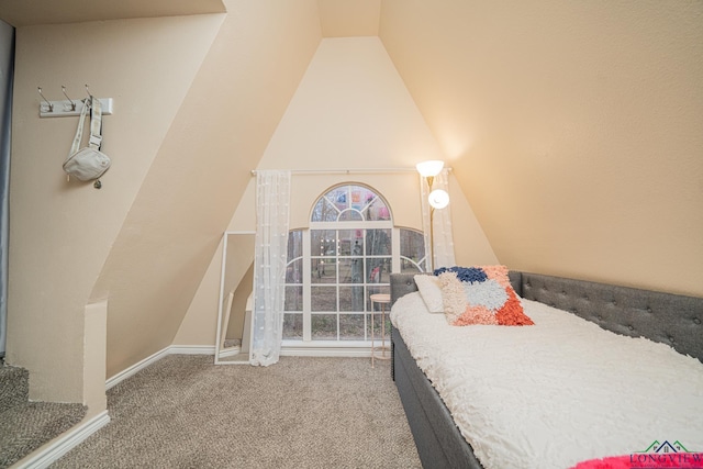 carpeted bedroom featuring vaulted ceiling and baseboards