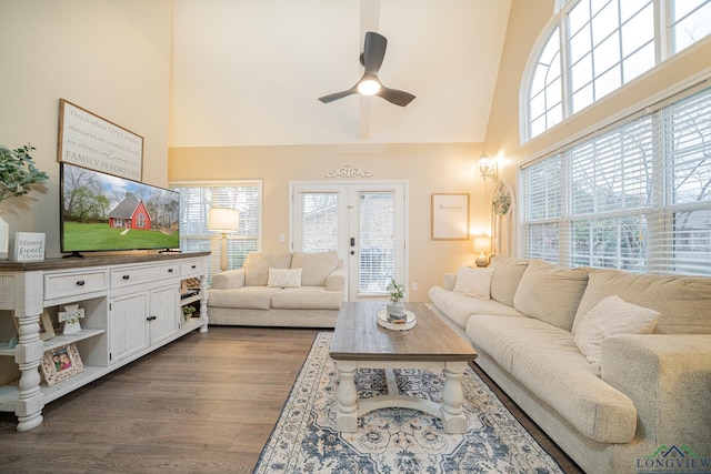 living room featuring dark wood-style floors, ceiling fan, a high ceiling, and french doors