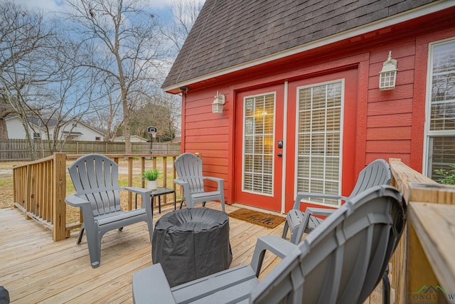 wooden deck featuring french doors and fence