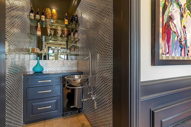 bar featuring wainscoting and a dry bar