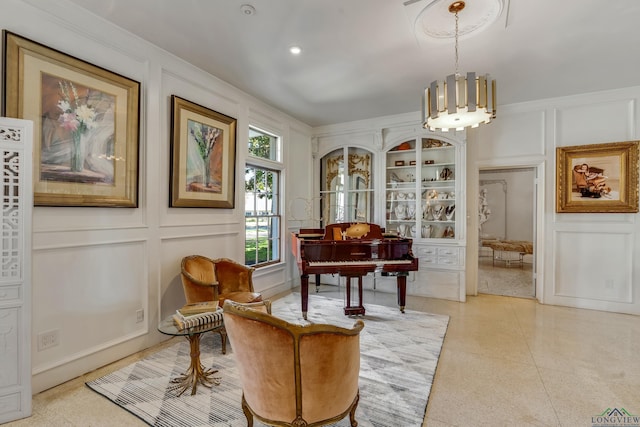 sitting room featuring light speckled floor and a decorative wall