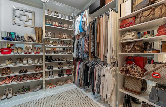 walk in closet with light tile patterned floors