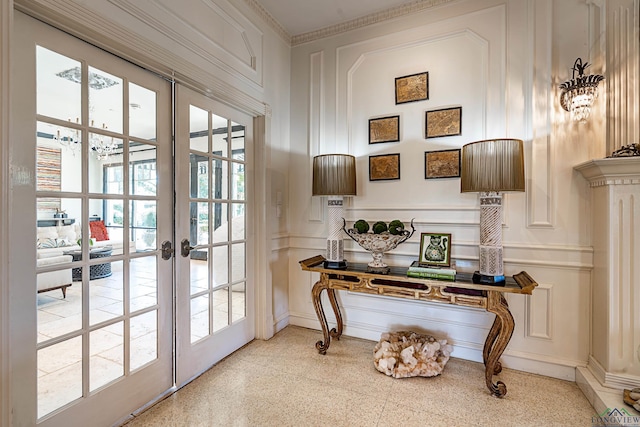 doorway with light speckled floor, french doors, and a decorative wall