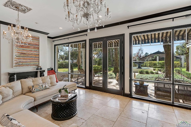 living area featuring a chandelier, french doors, ornamental molding, and stone tile floors