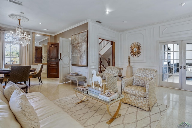 living area with crown molding, french doors, visible vents, and a decorative wall