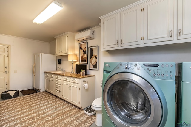 clothes washing area featuring laundry area, a wall mounted air conditioner, crown molding, separate washer and dryer, and a sink