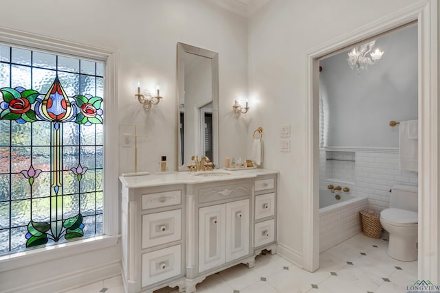 full bath featuring toilet, a wealth of natural light, a bath, and vanity