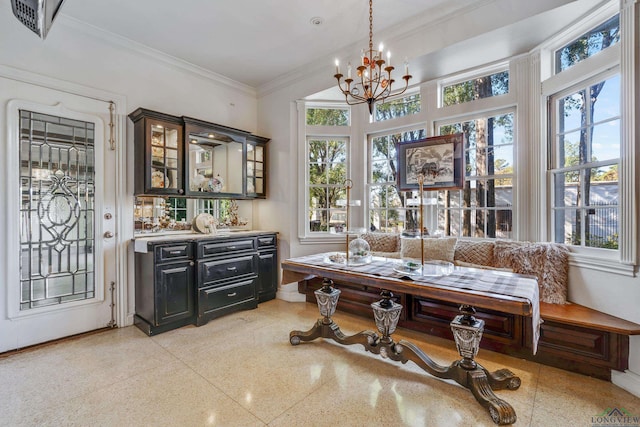 interior space with breakfast area, light speckled floor, crown molding, and a chandelier