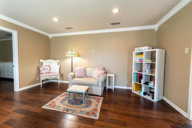 sitting room with ornamental molding and dark wood-type flooring