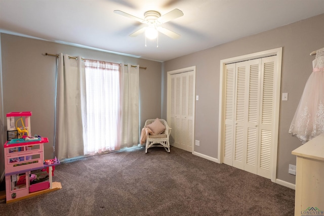 recreation room featuring dark colored carpet and ceiling fan