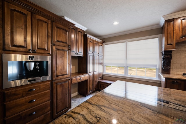 kitchen featuring dark brown cabinets, a textured ceiling, ornamental molding, and stainless steel oven