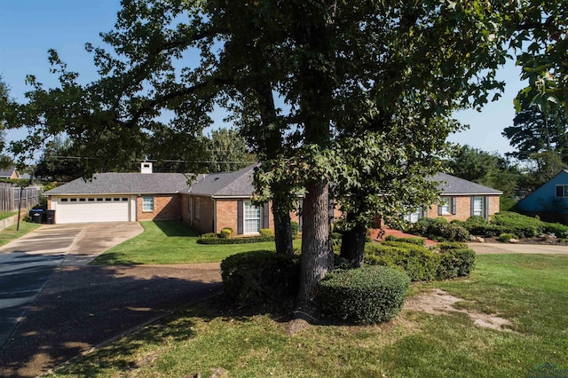 ranch-style house featuring a front lawn and a garage