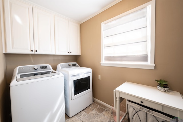 clothes washing area with cabinets, separate washer and dryer, and crown molding