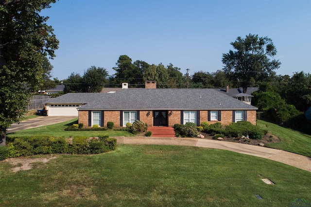 ranch-style house with a garage and a front lawn