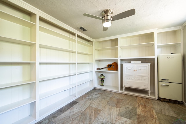 interior space featuring ceiling fan and a textured ceiling