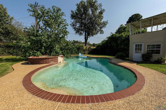 view of pool with a hot tub