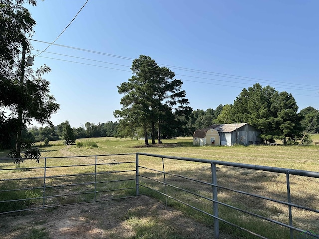 view of yard with a rural view