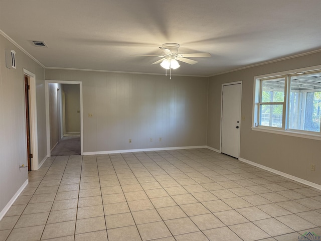 unfurnished room with ceiling fan, crown molding, and light tile patterned flooring