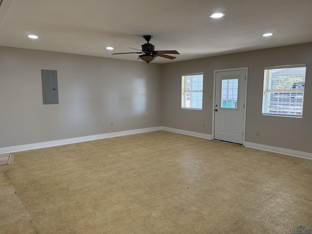 interior space with electric panel, ceiling fan, and a wealth of natural light