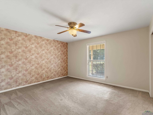 unfurnished room with ceiling fan and carpet floors