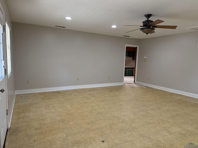 spare room featuring ceiling fan and a wealth of natural light