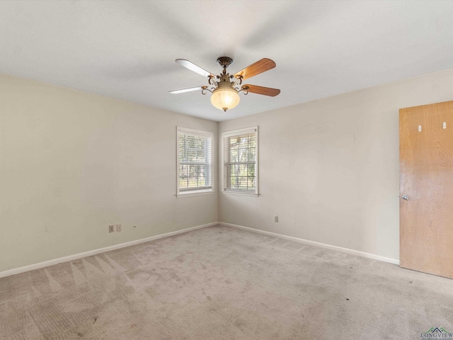 spare room featuring ceiling fan and light colored carpet