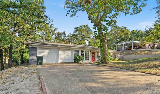 ranch-style house with a garage and a carport