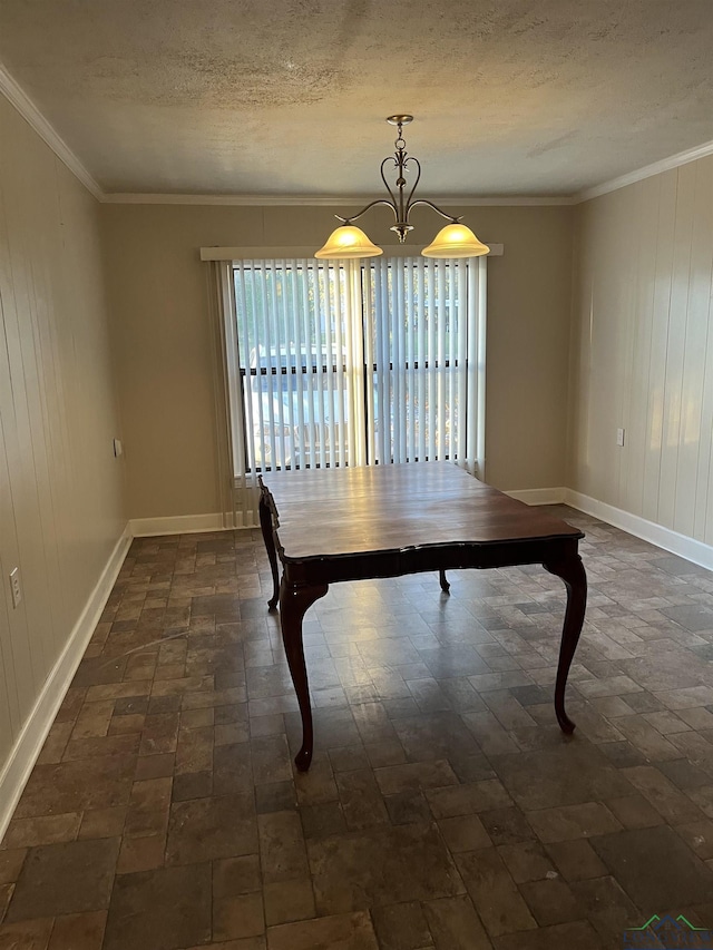 unfurnished dining area with ornamental molding and a textured ceiling