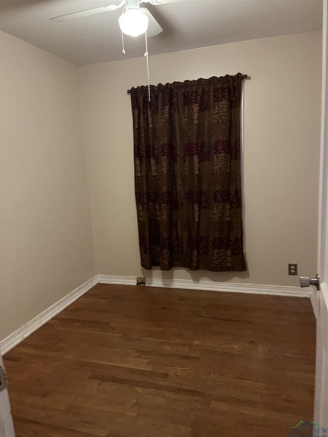 empty room with dark hardwood / wood-style floors and ceiling fan