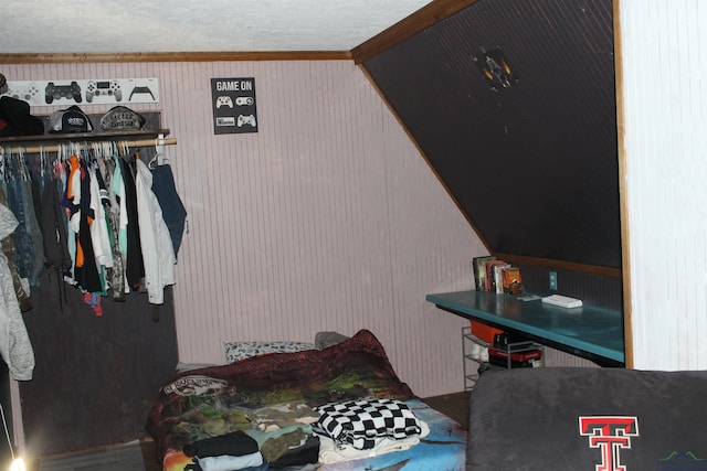 bedroom featuring ornamental molding and vaulted ceiling