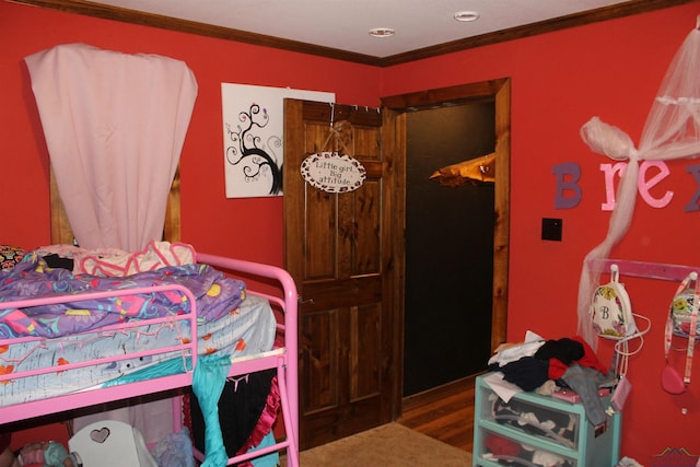 bedroom with hardwood / wood-style flooring and ornamental molding