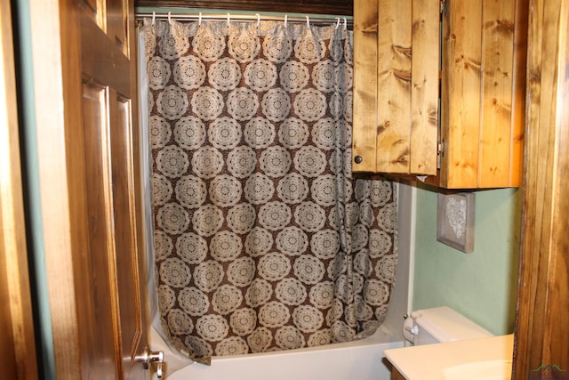 full bathroom featuring vanity, shower / tub combo, and toilet