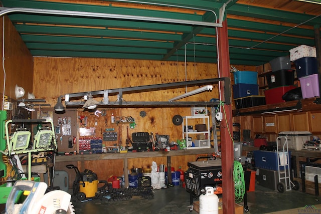 garage featuring a workshop area and wooden walls