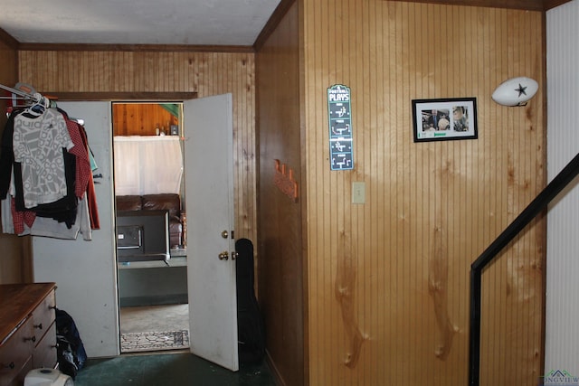 corridor featuring crown molding and wooden walls