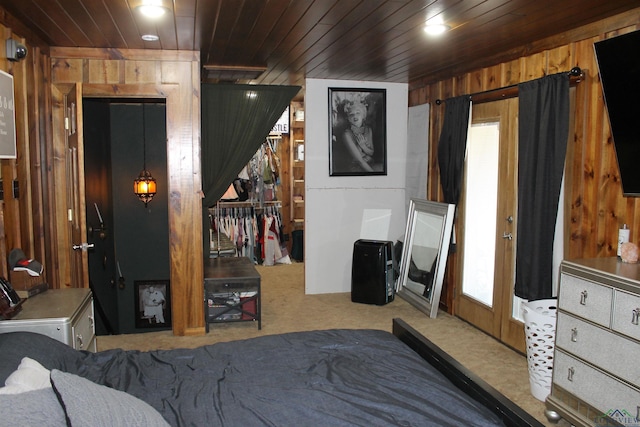 carpeted bedroom featuring wooden ceiling and wooden walls