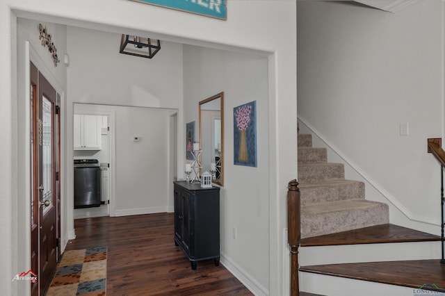 stairs with hardwood / wood-style floors and washer / dryer